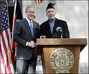 President George W. Bush and President Hamid Karzai of Afghanistan appear together in 2006 at a joint news conference at the Presidential Palace in Kabul.