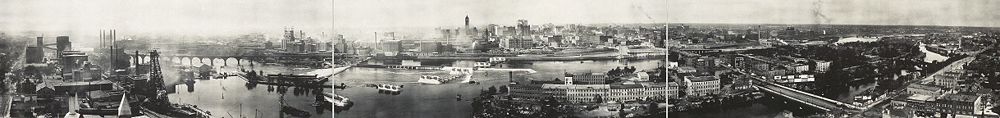 Mississippi riverfront and Saint Anthony Falls in 1915. At left, Pillsbury, power plants and the Stone Arch Bridge. Today the Minnesota Historical Society's Mill City Museum is in the Washburn "A" Mill, across the river just to the left of the falls. At center left are Northwestern Consolidated mills. The tall building is Minneapolis City Hall. In the foreground to the right are Nicollet Island and the Hennepin Avenue Bridge.