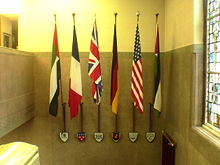 The arms of the twinned cities and their national flags alongside those of Dundee in the City Chambers.