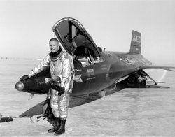 Armstrong stands next to the X-15 ship #1 after a research flight.
