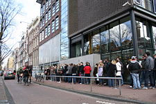 People waiting in line in front of the Anne Frank House entrance in Amsterdam