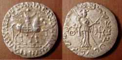 Silver coin of the Indo-Scythian king Azes II (r.c. 35–12 BCE). Buddhist triratna symbol in the left field on the reverse.