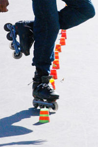 Inline roller skater on a slalom course