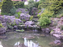 Formal rock garden pond with waterfall.