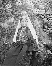A woman in Bethlehem. Her headdress and short jacket are typical of the Bethlehem area.