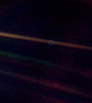 A photo of Earth (circled) taken by Voyager 1, 6.4 billion km (4 billion miles) away. The streaks of light are diffraction spikes radiating from the Sun (off frame to the left). This photograph is known as "Pale Blue Dot".