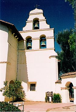 The three-bell campanario ("bell wall") at Mission San Juan Bautista. Two of the bells were salvaged from the original chime, which was destroyed in the 1906 San Francisco earthquake.