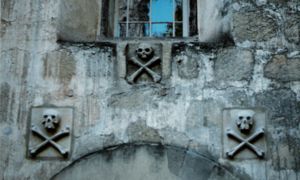 Actual skulls and crossbones were often used to mark the entrances to Spanish cemeteries (campo santos). Here, at Mission Santa Barbara, stone carvings were substituted.