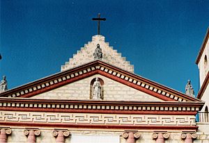A close-up view of the pediment situated above the chapel entrance at Mission Santa Barbara and its unique ornamental frieze.