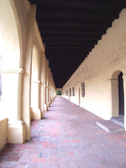 A view looking down a typical exterior corridor at Mission San Fernando Rey de España.