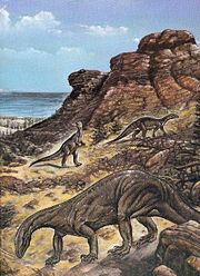 Outdated illustration of some Plateosaurus in a  desert-like environment.