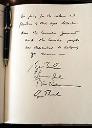 A note signed by former United States Presidents George H. W. Bush and Bill Clinton, First Lady Laura Bush, and President George W. Bush expressing their condolences during a visit to the embassy of Sri Lanka in Washington, D.C., Monday, January 3, 2005. The President wrote, “We pray for the victims and families of this epic disaster. And the American government and American people are dedicated to helping you recover.”