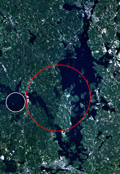 Keurusselkä - Landsat 7 image of the Keurusselkä region. Area where shatter cones have been found is marked with a red ellipse and the suggested impact structure of Ukonselkä is marked with a white circle.