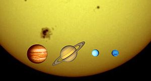 The solar system's four gas giants against the Sun's limb, to scale