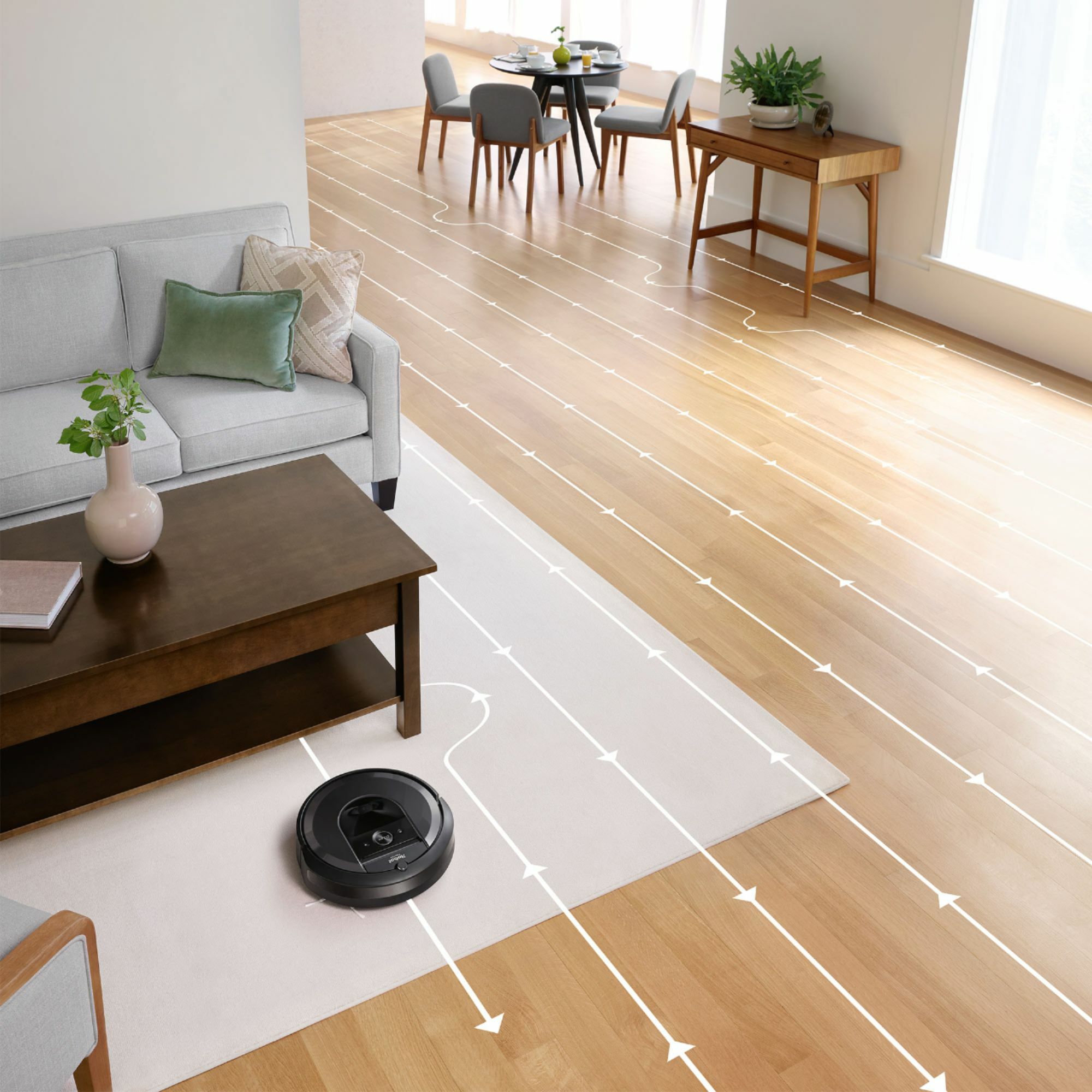 an irobot roomba i7+ vacuuming a living room in a path marked by white arrows