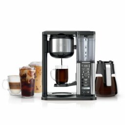 ninja specialty coffee maker with a glass carafe and three different sized cups of coffee