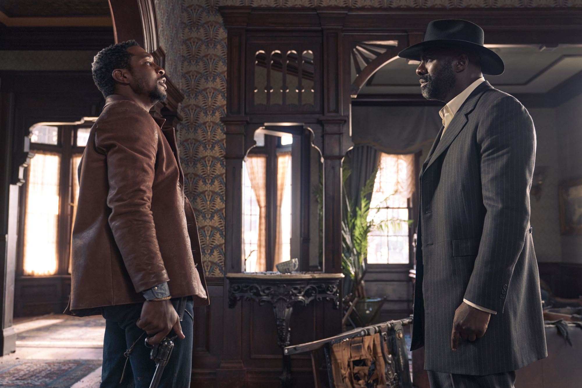 Jonathan Majors and Idris Elba face off in "The Harder They Fall."