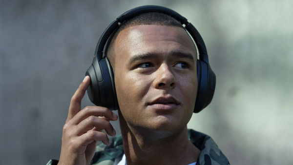 Man wearing black over the ear headphones.