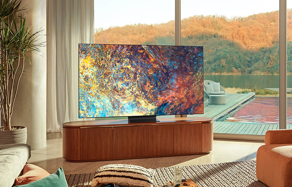 Samsung QN90A 4K QLED TV in living room with lake in the background