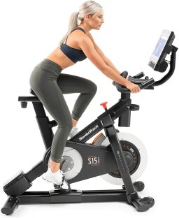 a woman riding the nordictrack commercial s15i studio cycle exercise bike