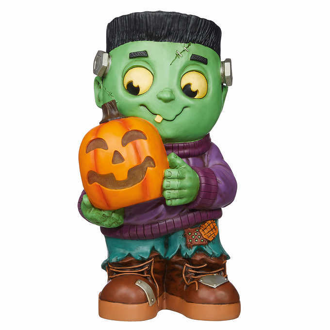 small frankenstein monster greeter holding a pumpkin