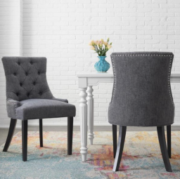 gray dining room chairs around table on colorful rug