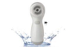 White facial cleansing brush on water