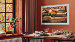 Dining room with a set table and a tv that looks like a picture frame