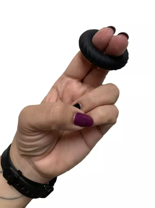 a hand holding a cock ring