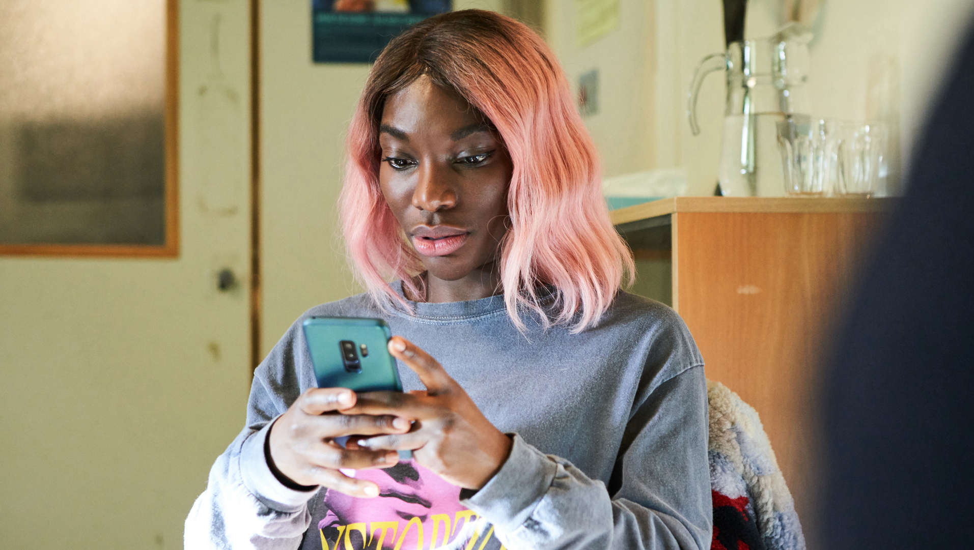 A picture of Arabella (Michaela Coel) looking at her phone in "I May Destroy You."