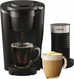 Coffee maker and milk frother next to latte in a cup.