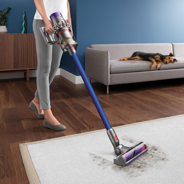 woman vacuuming carpet with cordless Dyson V10 Allergy vacuum