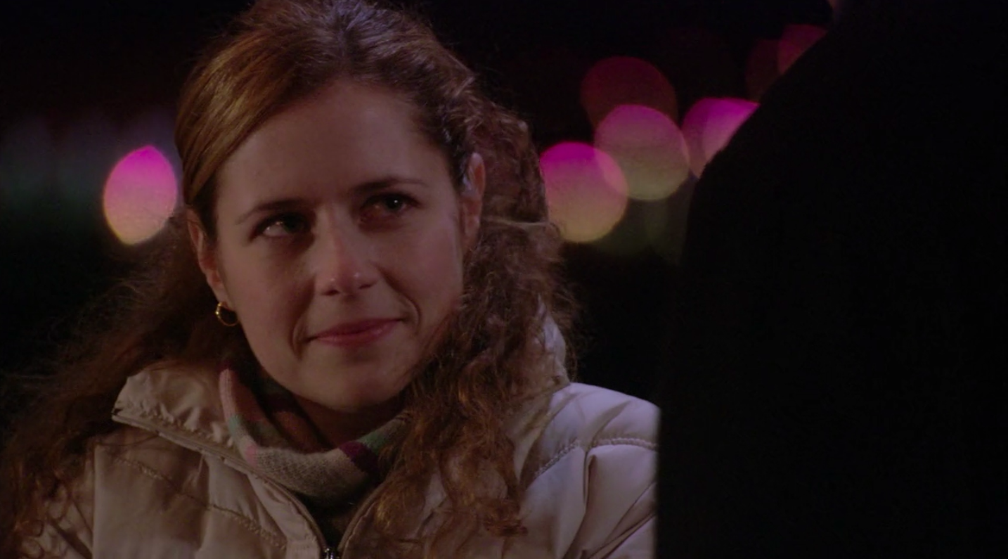 A photo of Jenna Fischer as Pam Beesly in "The Office" staring up at Jim.