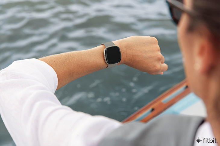 Woman looking at fitbit on wrist