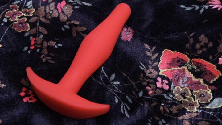 red tantus little flirt anal toy on a soft blanket