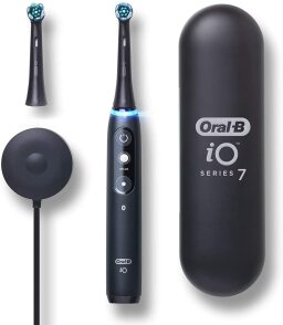 Black electric toothbrush with extra brushhead, case, and charging stand