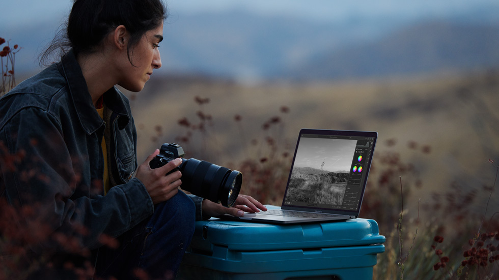 Woman looking at a laptop outside