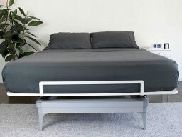 Dark grey bed with two pillows