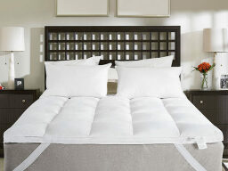White bed with wooden frame and two bedside tables