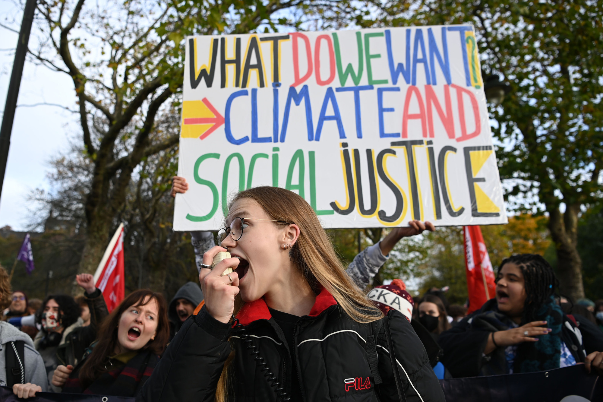 A Fridays For Future leader rallies up the crowd as they head to George Square.