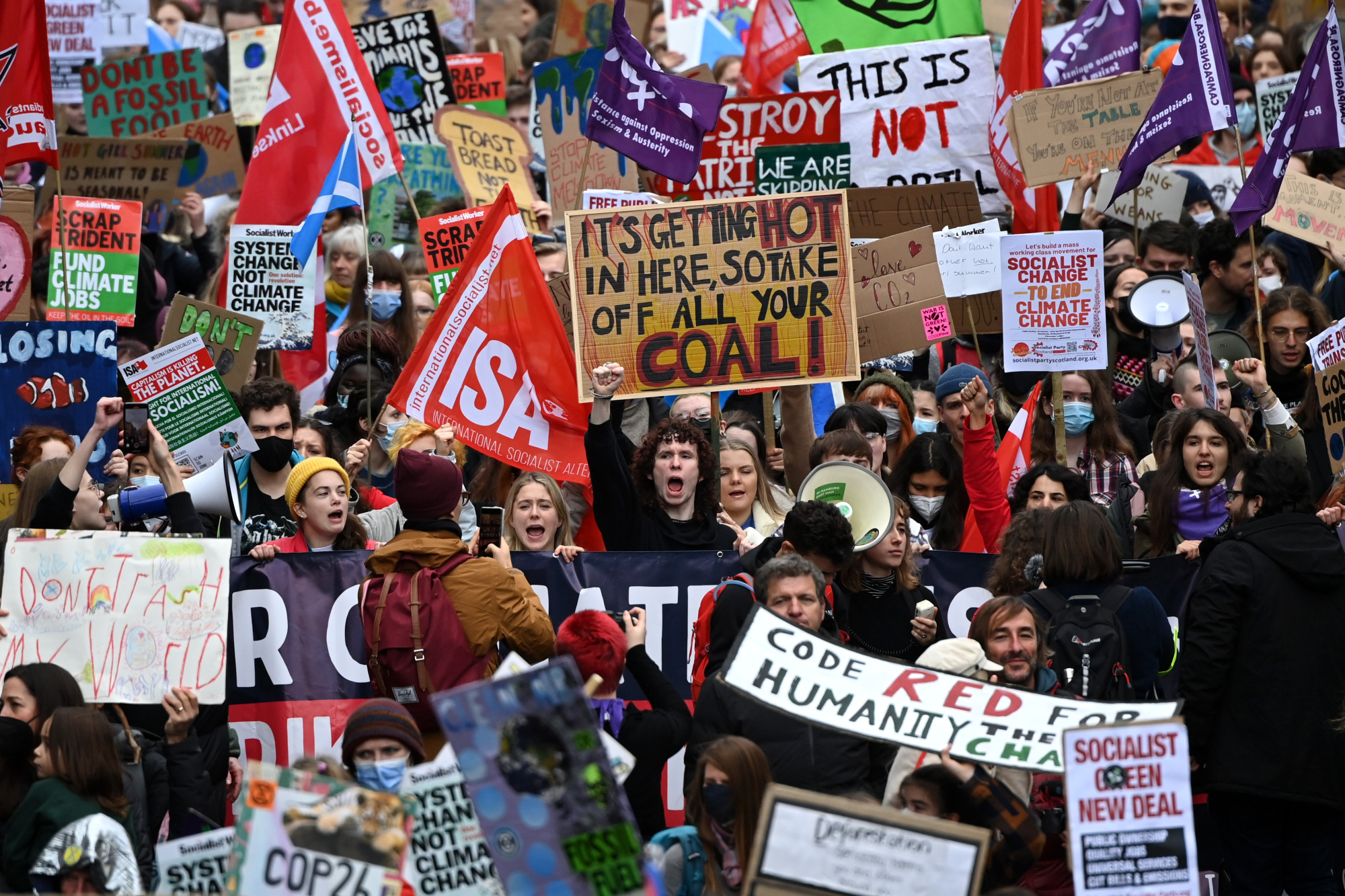 Numerous signs are held aloft by youth activists, including references to Finding Nemo and Nelly's "Hot In Here".