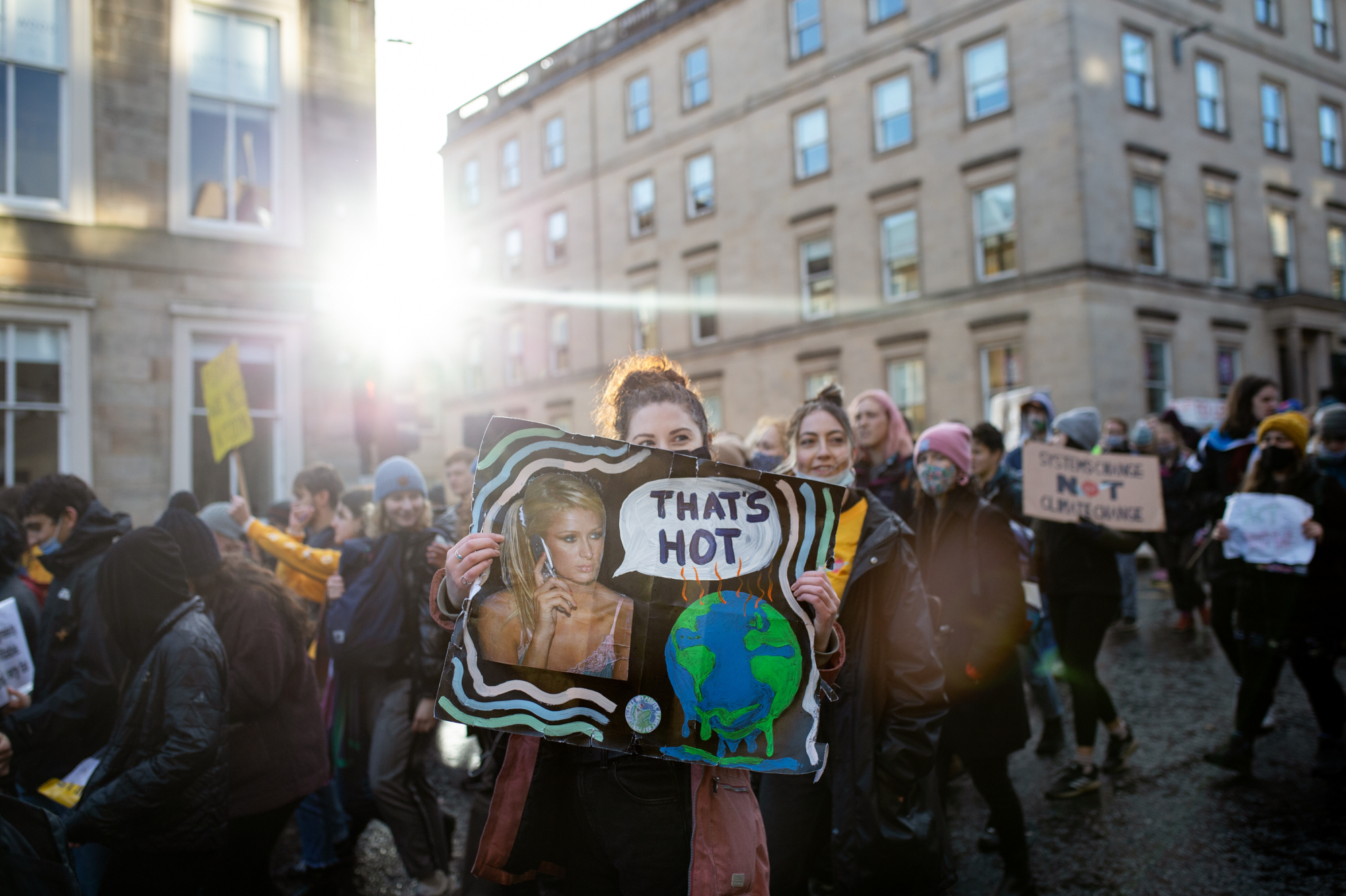A climate activist holds a Paris Hilton-inspired sign during a "Global Day of Action" protest in Glasgow.
