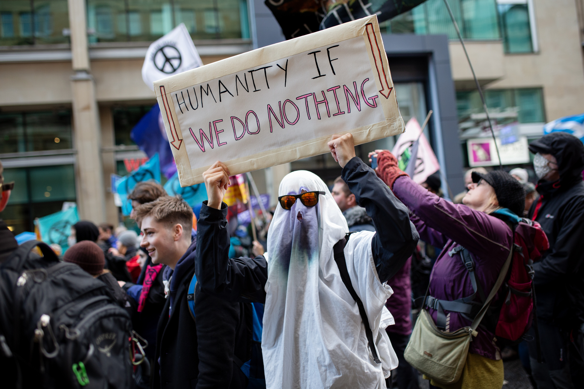 Protesters hold signs at the climate protests in Glasgow.