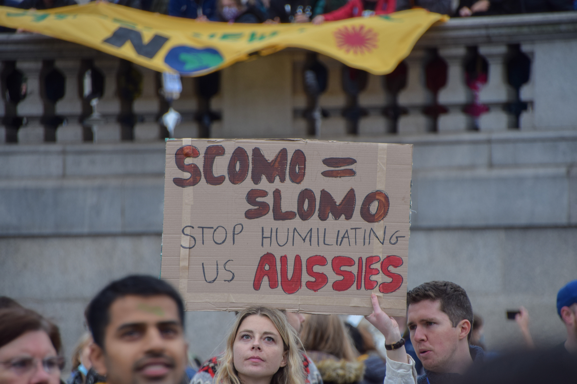 A protester holds a placard critical of Australian Prime Minister Scott Morrison during the demonstration in Trafalgar Square, London.