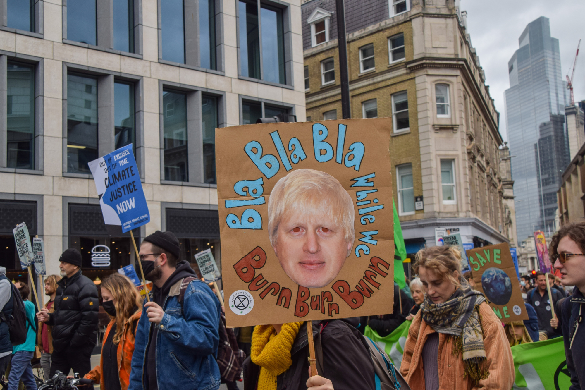 A protester holds a placard critical of Boris Johnson during the demonstration in London.