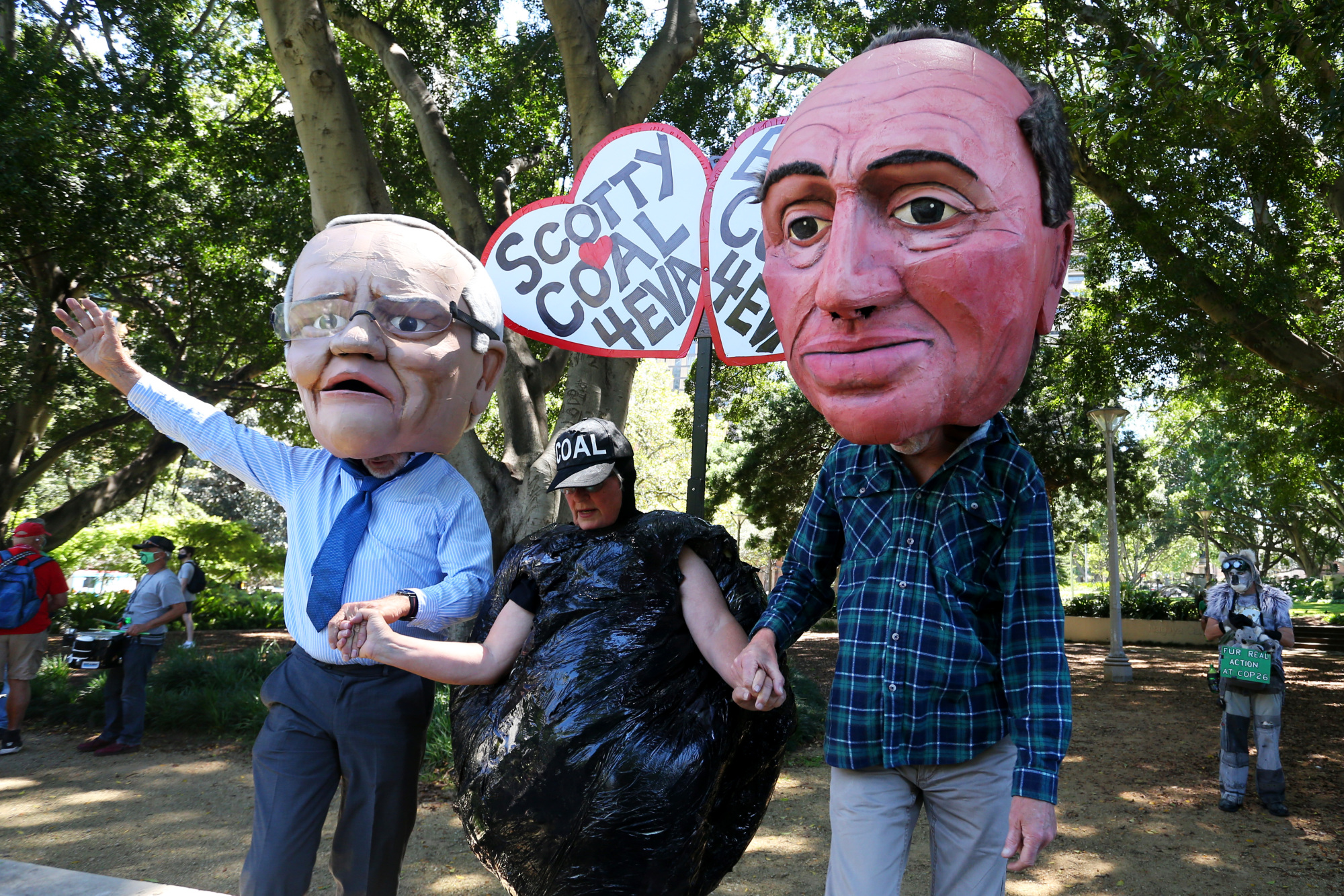 Climate activists dressed as Prime Minister Scott Morrison and Deputy Prime Minister Barnaby Joyce in Sydney's Hyde Park.