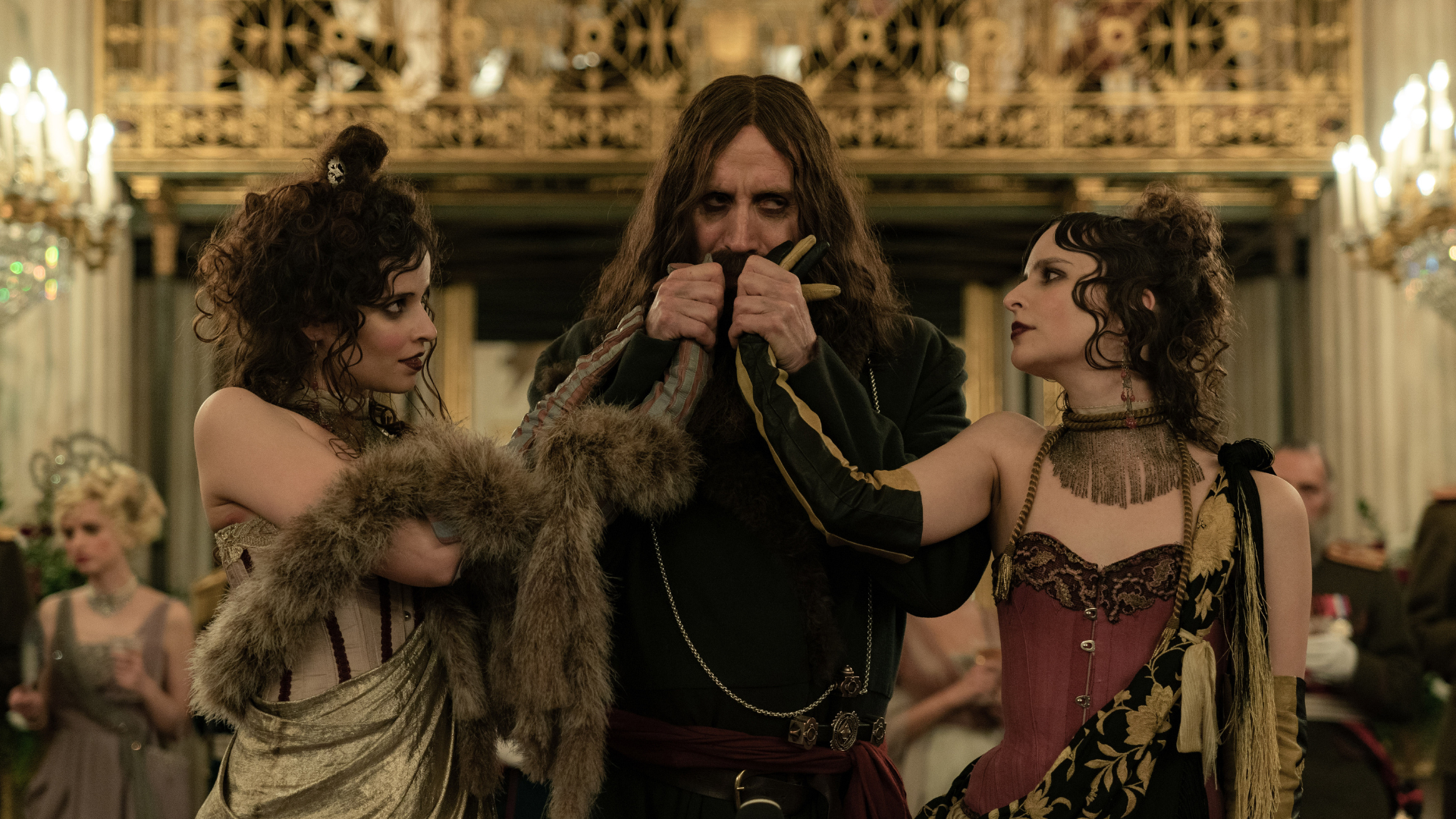 Rhys Ifans as Rasputin, who is lustily kissing women's hands, in "the King's Man."