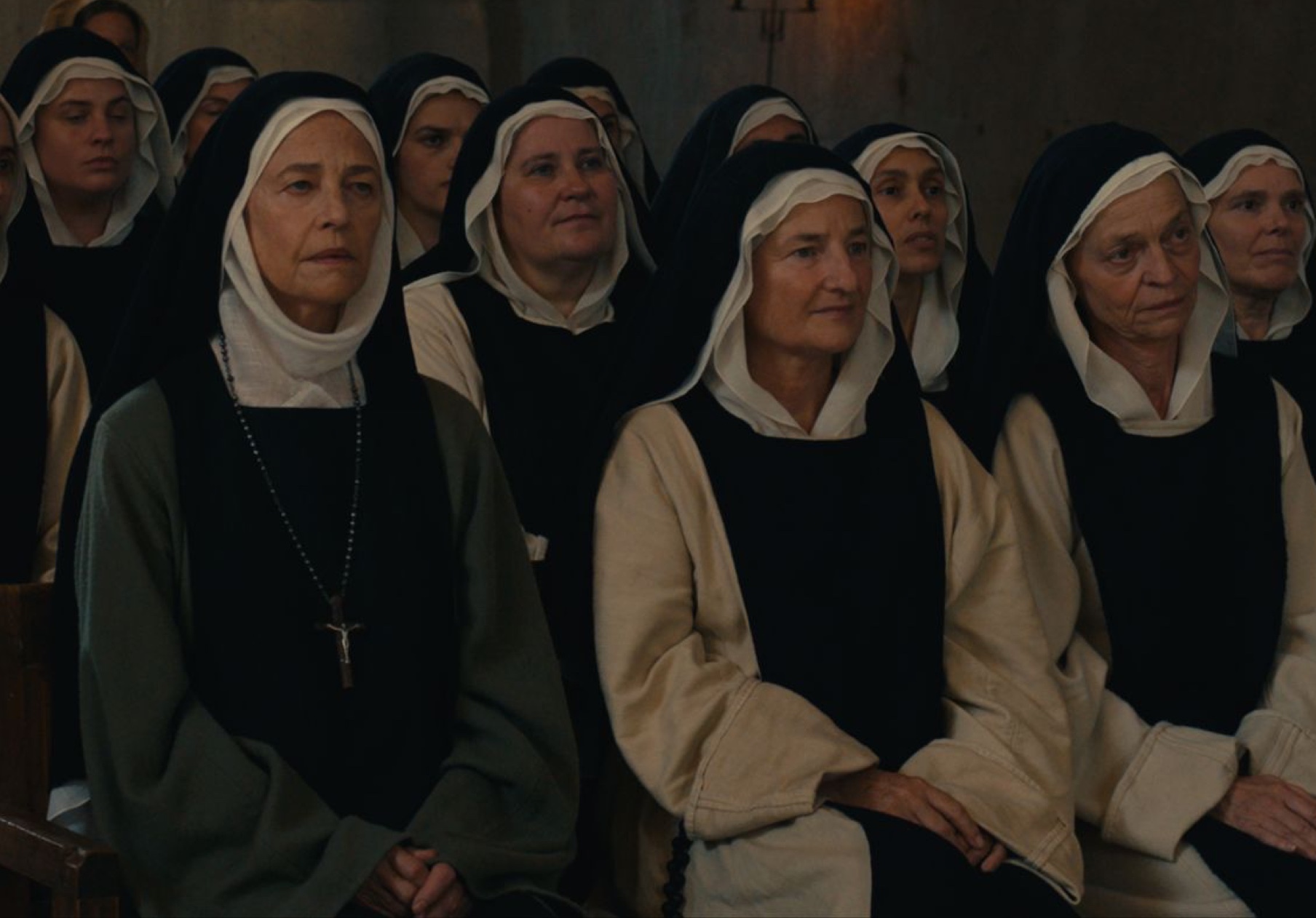 a group of nuns sit together in silence. 