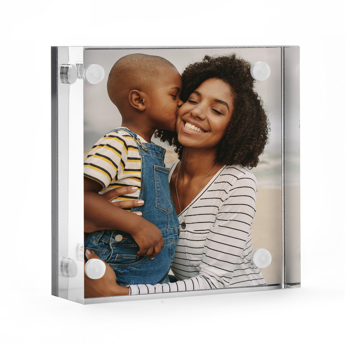 photo in acrylic frame of son kissing his mom