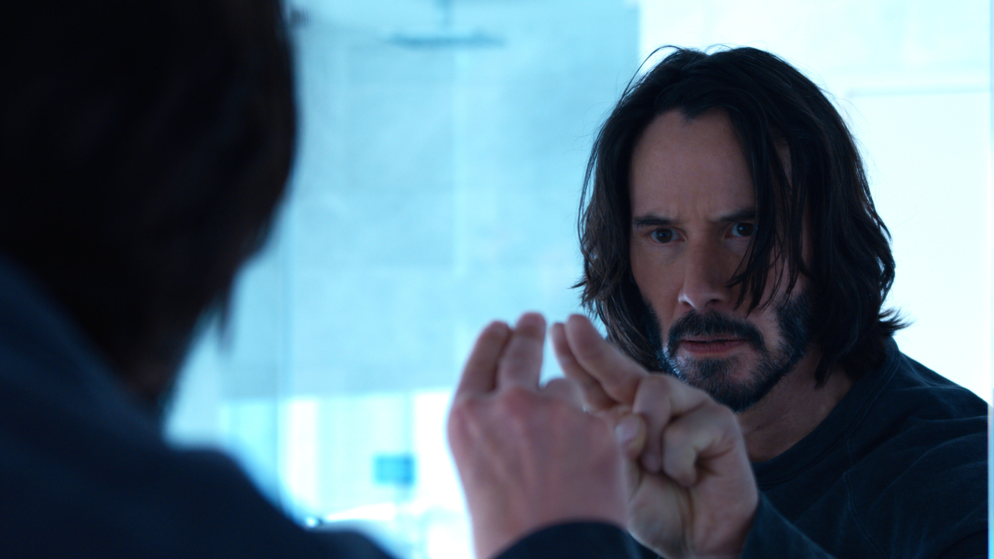 A man points at himself in the mirror.